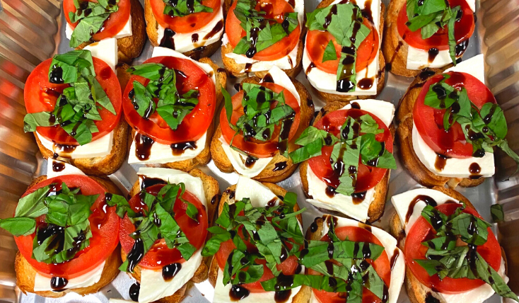 Overhead picture of a catering tray full of fresh bruschetta.